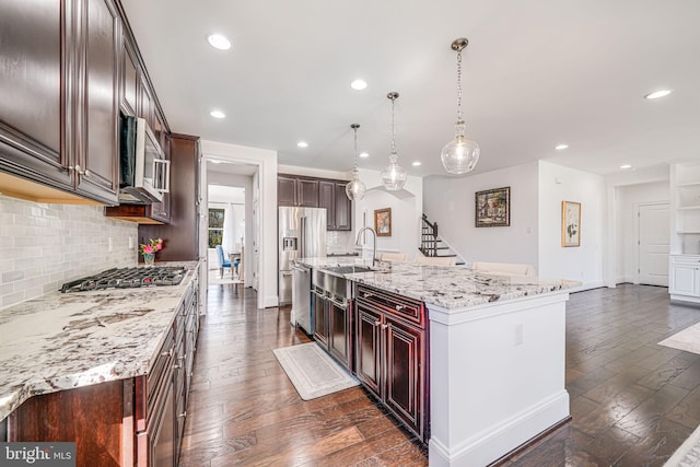 24642 Black Willow Dr, Aldie, VA 20105 - kitchen featuring dark wood-style floors, recessed lighting, appliances with stainless steel finishes, a sink, and backsplash