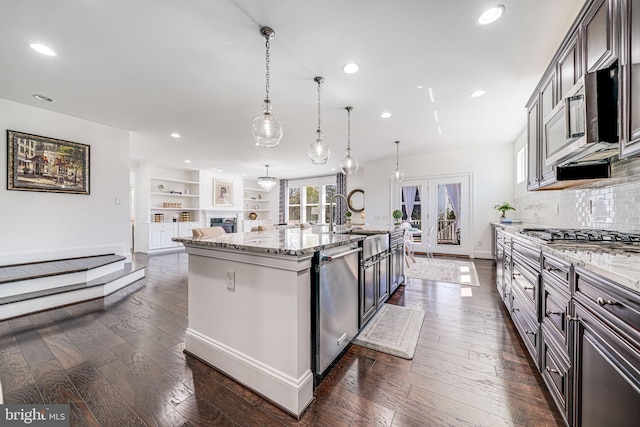 24642 Black Willow Dr, Aldie, VA 20105 - kitchen with a sink, dark wood-style flooring, appliances with stainless steel finishes, a kitchen island with sink, and light stone counters