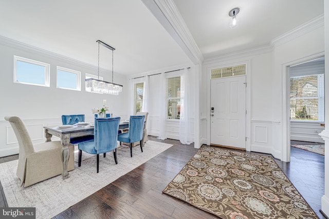 24642 Black Willow Dr, Aldie, VA 20105 - dining area featuring a decorative wall, a chandelier, dark wood-style floors, crown molding, and a wainscoted wall