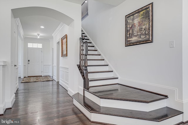 24642 Black Willow Dr, Aldie, VA 20105 - entryway featuring crown molding, stairs, hardwood / wood-style floors, a decorative wall, and arched walkways