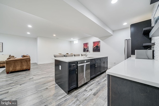 24642 Black Willow Dr, Aldie, VA 20105 - kitchen featuring open floor plan, light wood-style flooring, light countertops, stainless steel appliances, and a sink