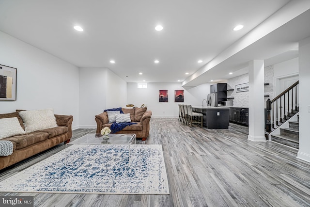 24642 Black Willow Dr, Aldie, VA 20105 - living room featuring baseboards, light wood-type flooring, recessed lighting, and stairs