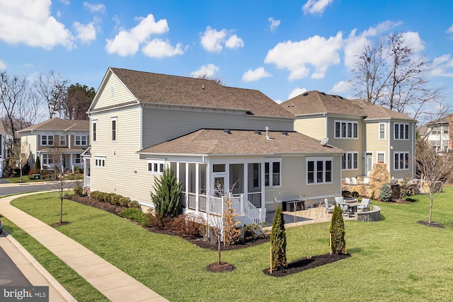 24642 Black Willow Dr, Aldie, VA 20105 - rear view of house with a sunroom, a yard, a patio area, a shingled roof, and a residential view