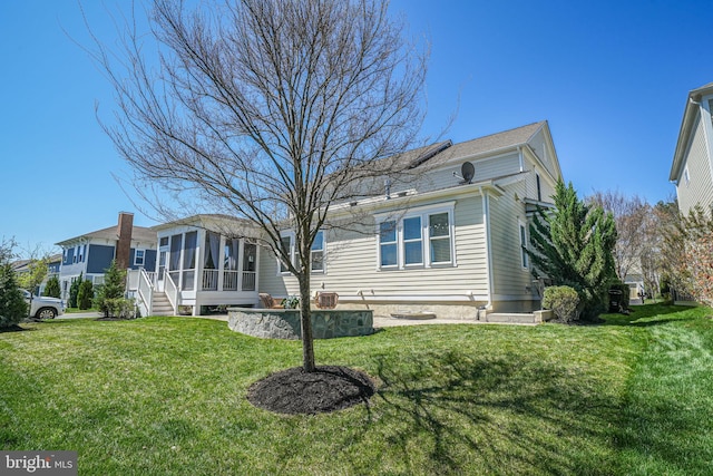24642 Black Willow Dr, Aldie, VA 20105 - rear view of property with a sunroom and a lawn