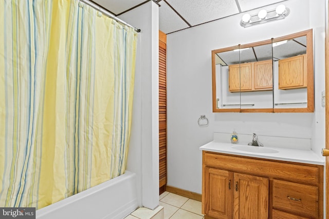 full bath with shower / bath combo, tile patterned floors, vanity, and baseboards