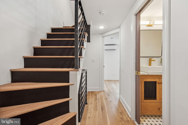 1129 E Berks St, Philadelphia, PA 19125 - stairway featuring baseboards, a wall mounted air conditioner, and wood finished floors