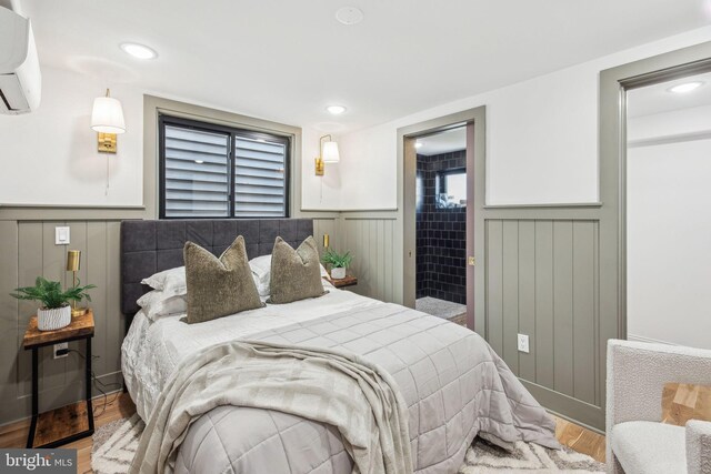 1129 E Berks St, Philadelphia, PA 19125 - bedroom with a wainscoted wall, a wall unit AC, wood finished floors, and recessed lighting