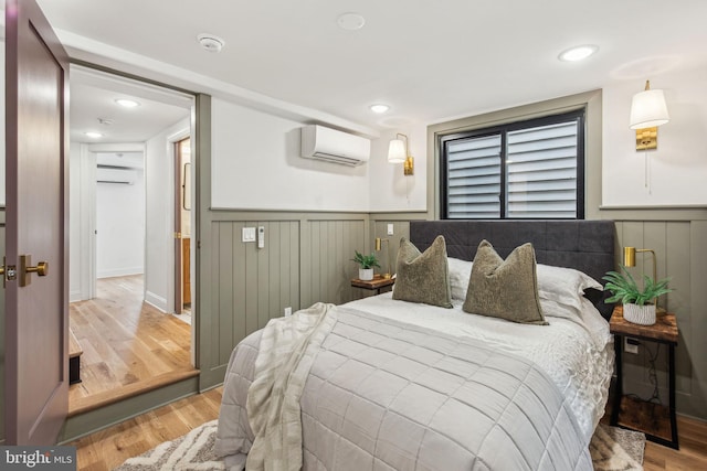 1129 E Berks St, Philadelphia, PA 19125 - bedroom featuring a wall mounted air conditioner, light wood-style flooring, recessed lighting, and wainscoting