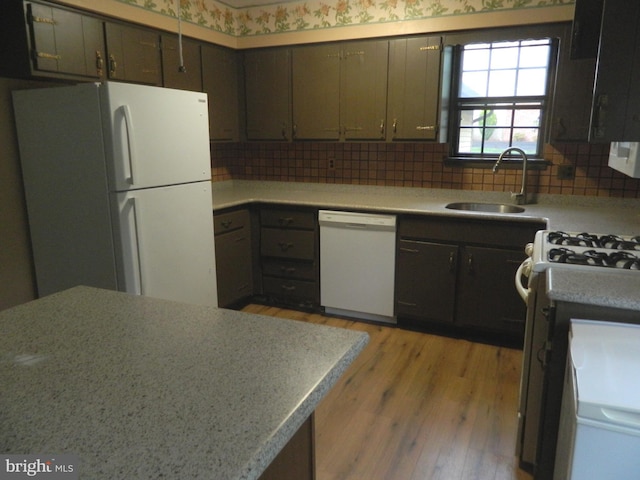 134 Country Ln, Sicklerville, NJ 08081 - kitchen with white appliances, a sink, light wood-type flooring, decorative backsplash, and light countertops