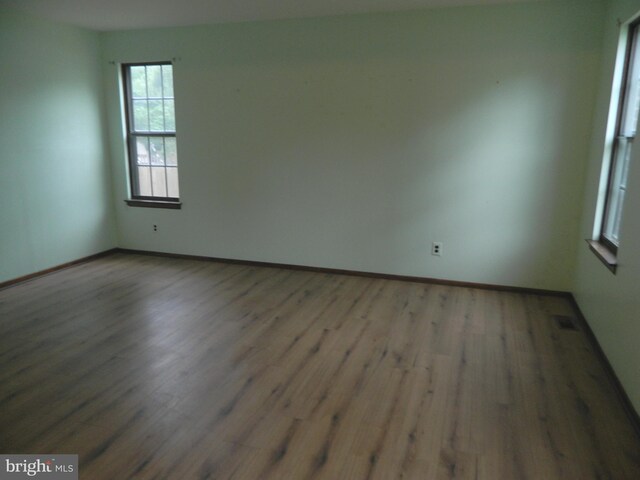 134 Country Ln, Sicklerville, NJ 08081 - unfurnished room with wood finished floors, plenty of natural light, and baseboards