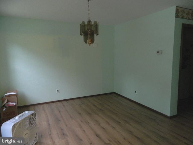 134 Country Ln, Sicklerville, NJ 08081 - unfurnished dining area with a chandelier, wood finished floors, and baseboards