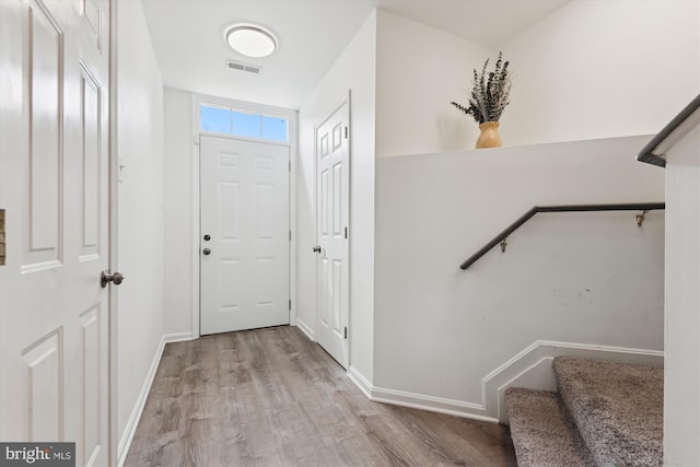 entryway featuring wood finished floors, visible vents, and baseboards