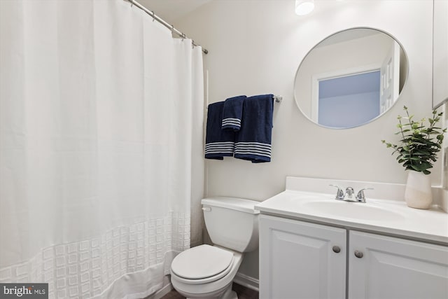 bathroom featuring toilet and vanity