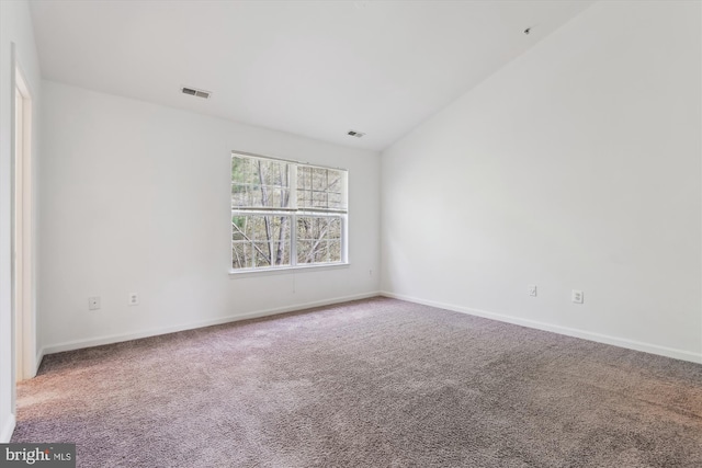 carpeted empty room with baseboards and visible vents