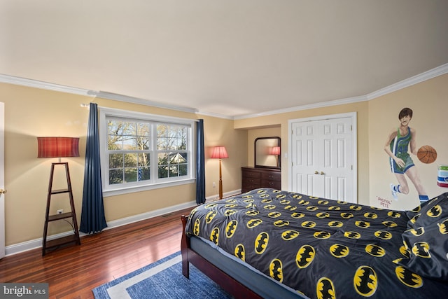 bedroom featuring a closet, baseboards, ornamental molding, and hardwood / wood-style flooring