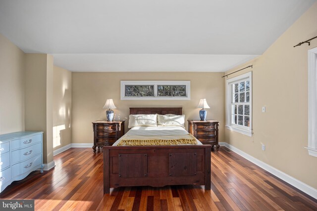 bedroom featuring dark wood-type flooring and baseboards