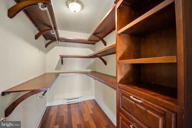spacious closet with dark wood-type flooring