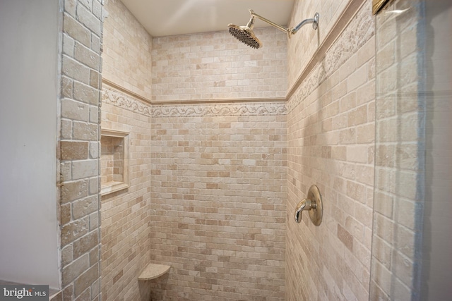 bathroom with tiled shower