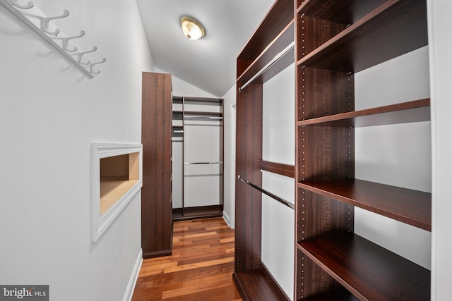 spacious closet with wood finished floors and lofted ceiling