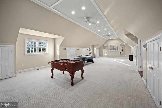 recreation room featuring baseboards, light colored carpet, vaulted ceiling, and a ceiling fan