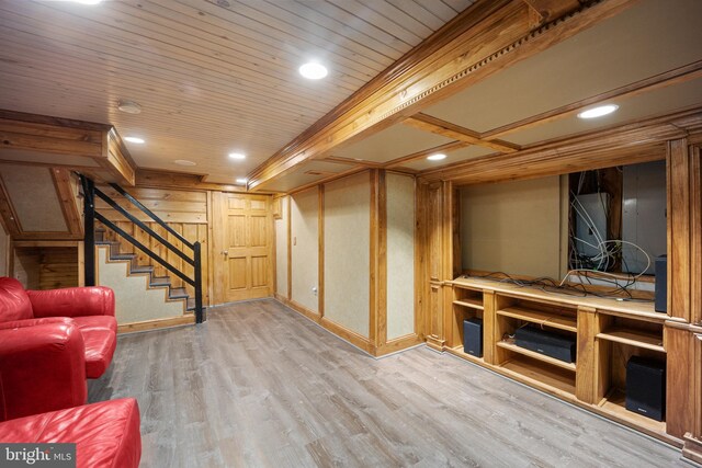 below grade area with wood finished floors, recessed lighting, baseboards, and stairway