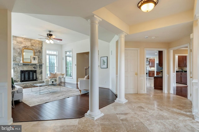 18102 Eaglesham Ct, Leesburg, VA 20175 - entryway featuring ornate columns, a ceiling fan, and a fireplace