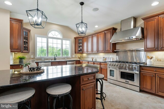18102 Eaglesham Ct, Leesburg, VA 20175 - kitchen with appliances with stainless steel finishes, wall chimney range hood, a kitchen bar, tasteful backsplash, and glass insert cabinets