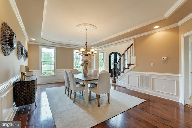 18102 Eaglesham Ct, Leesburg, VA 20175 - dining room with a chandelier, a raised ceiling, stairs, dark wood-style flooring, and a wainscoted wall