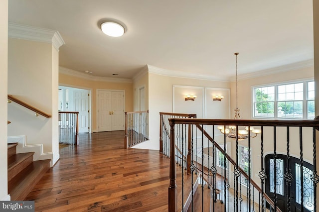 18102 Eaglesham Ct, Leesburg, VA 20175 - corridor featuring hardwood / wood-style floors, a chandelier, an upstairs landing, ornamental molding, and baseboards