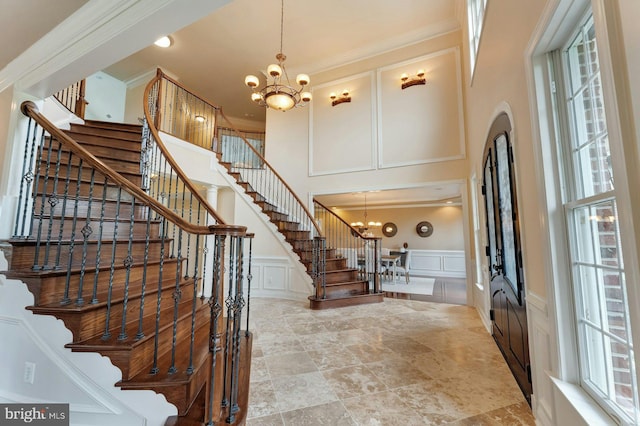 18102 Eaglesham Ct, Leesburg, VA 20175 - entrance foyer featuring a chandelier, a decorative wall, stairs, plenty of natural light, and a towering ceiling