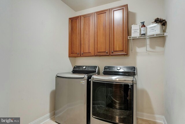18102 Eaglesham Ct, Leesburg, VA 20175 - clothes washing area featuring separate washer and dryer, cabinet space, and baseboards