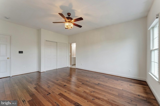 18102 Eaglesham Ct, Leesburg, VA 20175 - unfurnished bedroom featuring dark wood-type flooring, multiple windows, a closet, and baseboards