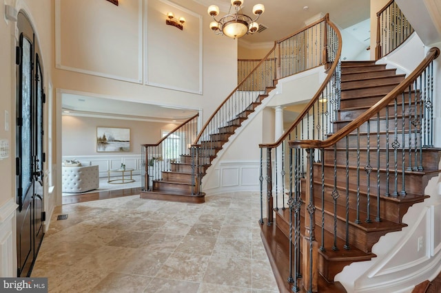 18102 Eaglesham Ct, Leesburg, VA 20175 - entrance foyer with stairs, a decorative wall, a towering ceiling, a chandelier, and ornamental molding