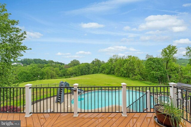 18102 Eaglesham Ct, Leesburg, VA 20175 - view of pool with a lawn, a water slide, view of scattered trees, and a wooden deck