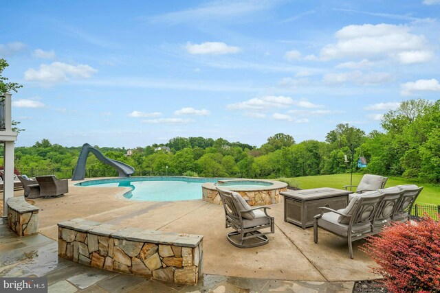 18102 Eaglesham Ct, Leesburg, VA 20175 - view of swimming pool featuring a water slide, a patio area, and a pool with connected hot tub