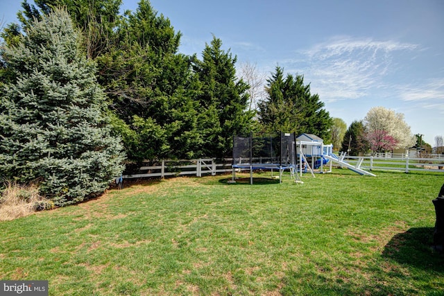 24 W Shakespeare Dr, Middletown, DE 19709 - view of yard featuring a trampoline and a playground
