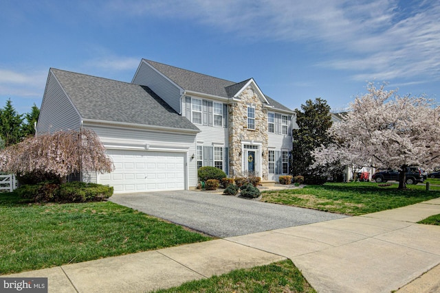 24 W Shakespeare Dr, Middletown, DE 19709 - colonial inspired home with driveway, an attached garage, a front lawn, stone siding, and roof with shingles