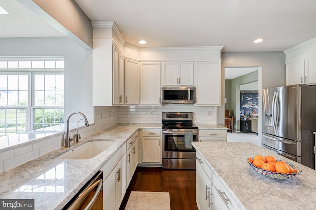 24 W Shakespeare Dr, Middletown, DE 19709 - kitchen featuring stainless steel appliances, a sink, dark wood-style floors, light stone countertops, and tasteful backsplash