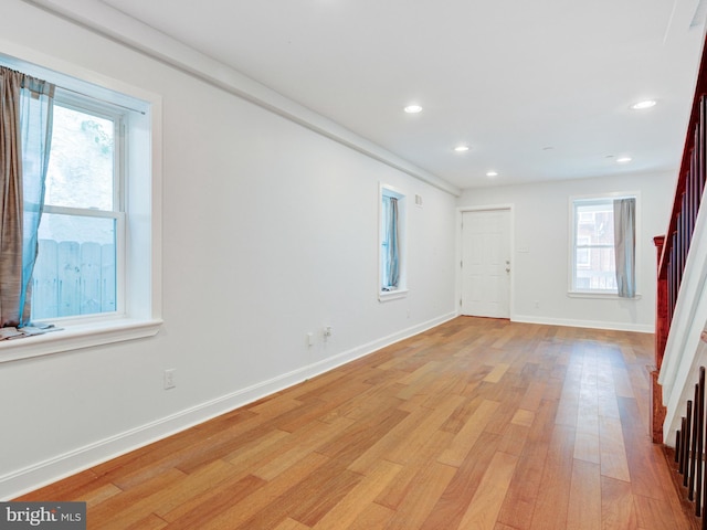 2671 Emerald St, Philadelphia, PA 19125 - empty room featuring light wood-style flooring, baseboards, a wealth of natural light, and stairway