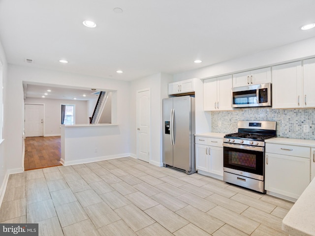 2671 Emerald St, Philadelphia, PA 19125 - kitchen featuring light countertops, white cabinets, backsplash, and stainless steel appliances