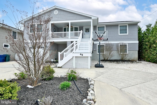 view of front of property featuring stairway, a porch, and ceiling fan