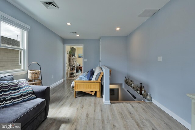 interior space featuring recessed lighting, wood finished floors, visible vents, and baseboards