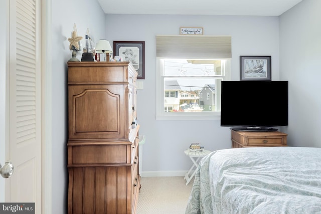 bedroom featuring baseboards and carpet