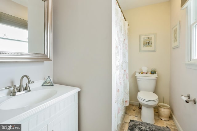 full bathroom with toilet and vanity