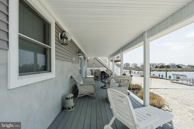 wooden terrace featuring a water view