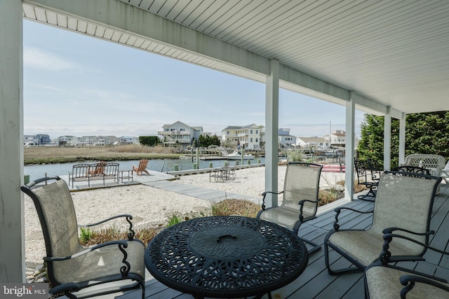 wooden terrace featuring a water view