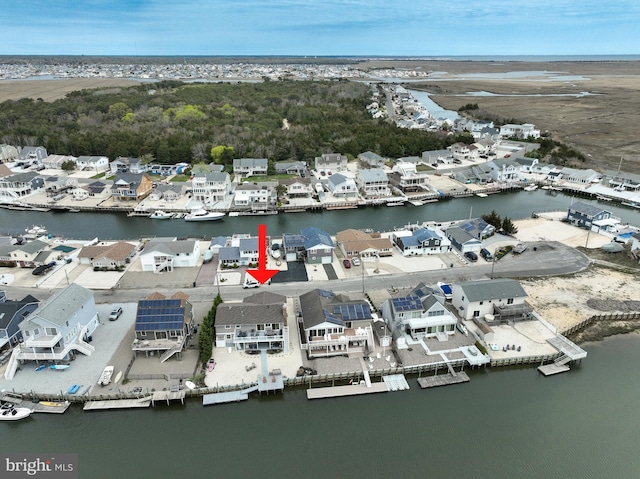 drone / aerial view with a residential view and a water view