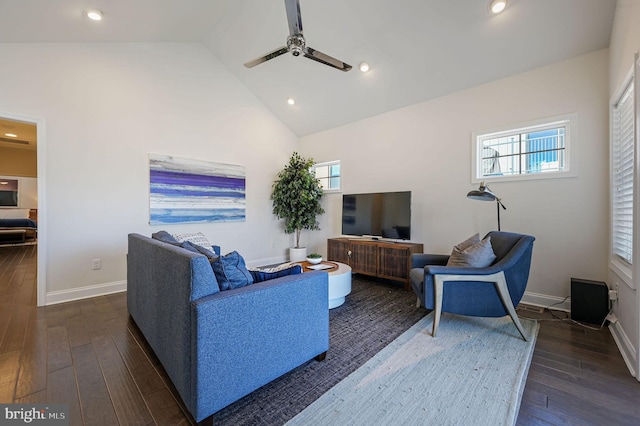 living room with baseboards, dark wood-style flooring, high vaulted ceiling, and a ceiling fan
