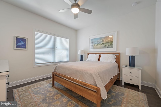 bedroom featuring baseboards, wood finished floors, and ceiling fan