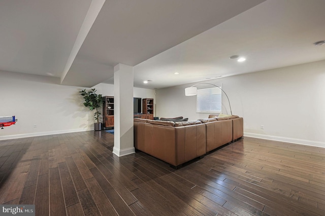living area featuring baseboards, recessed lighting, and dark wood-type flooring